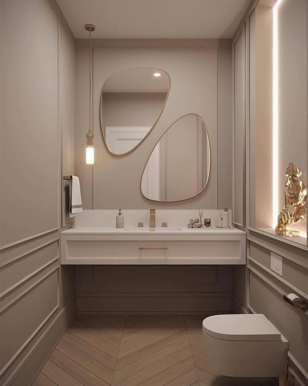Warm powder room with sculptural mirrors